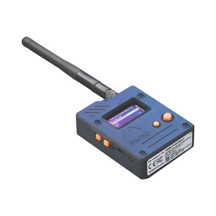 A Seeed Studio Wio Tracker L1 Pro LoRa mesh node with its antenna fitted, showing the small color display and side buttons used to run MeshCore