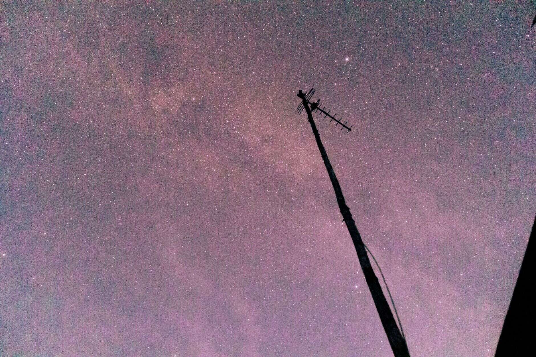 An antenna silhouetted against a star filled night sky, when the low bands of 160, 80 and 40 meters come alive